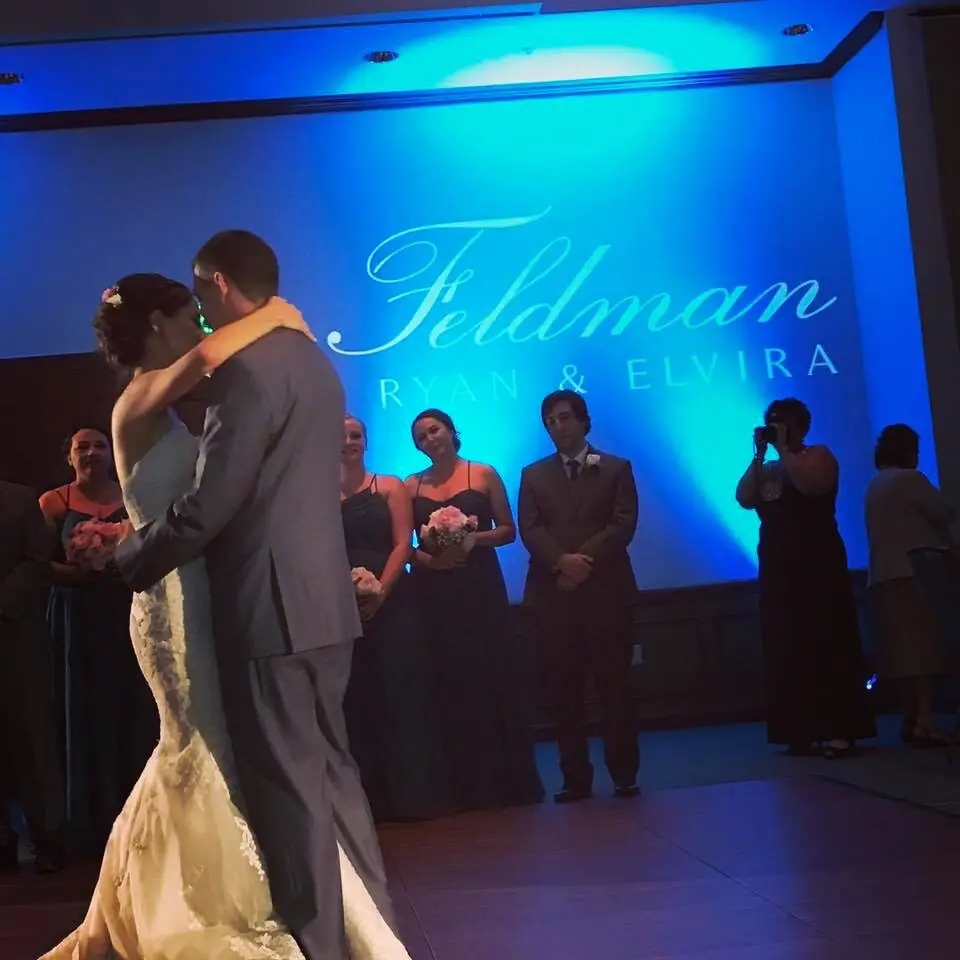 Ice blue uplighting and a custom monogram during a first dance